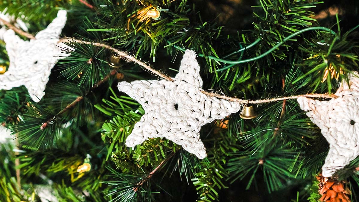 A homemade crocheted star garland on a Christmas tree.