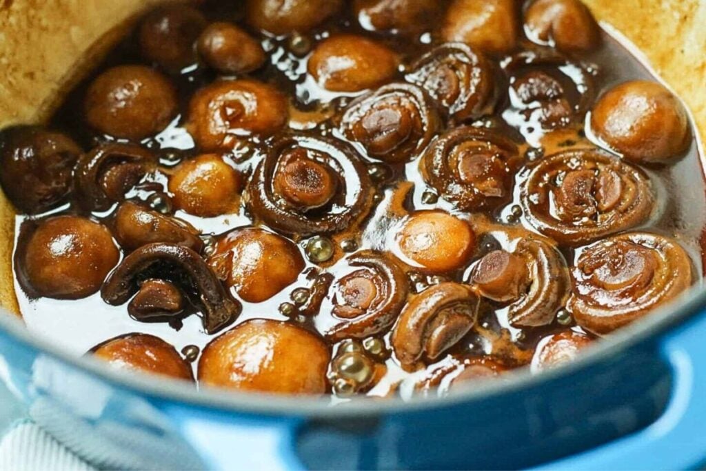 A bowl of beer braised whole mushrooms.