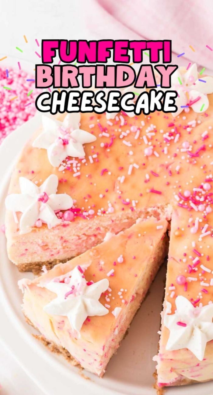 A Funfetti Birthday Cheesecake topped with whipped cream and pink sprinkles, with one slice cut out for a festive treat.