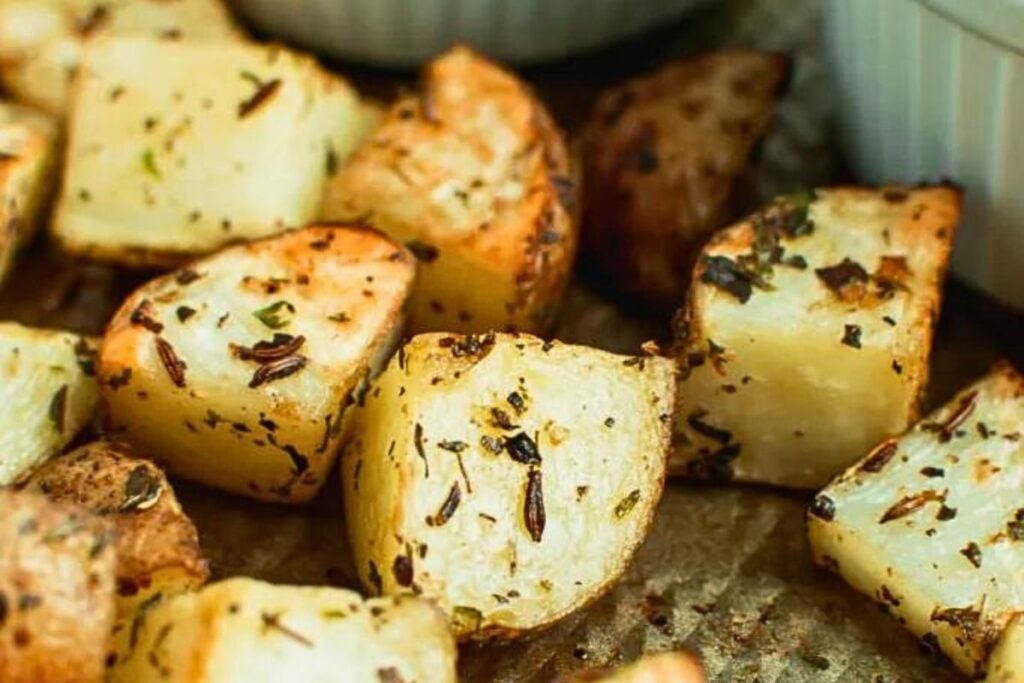 A platter of herb roasted potatoes with dipping sauces.