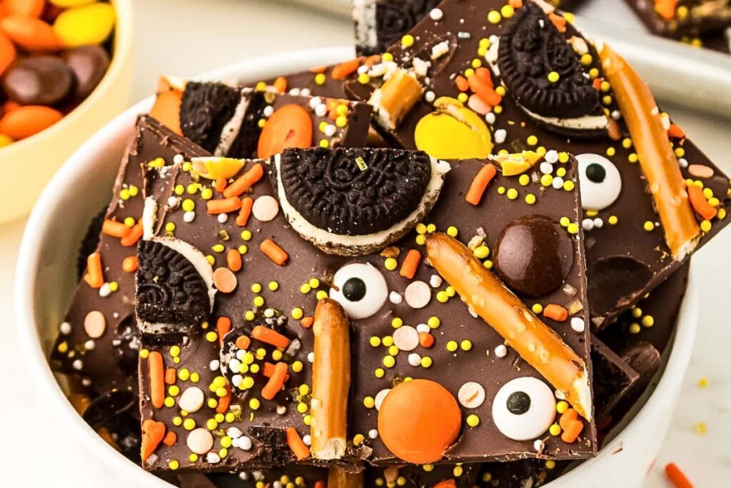Chocolate bark with halloween candy, pretzels and cookies.
