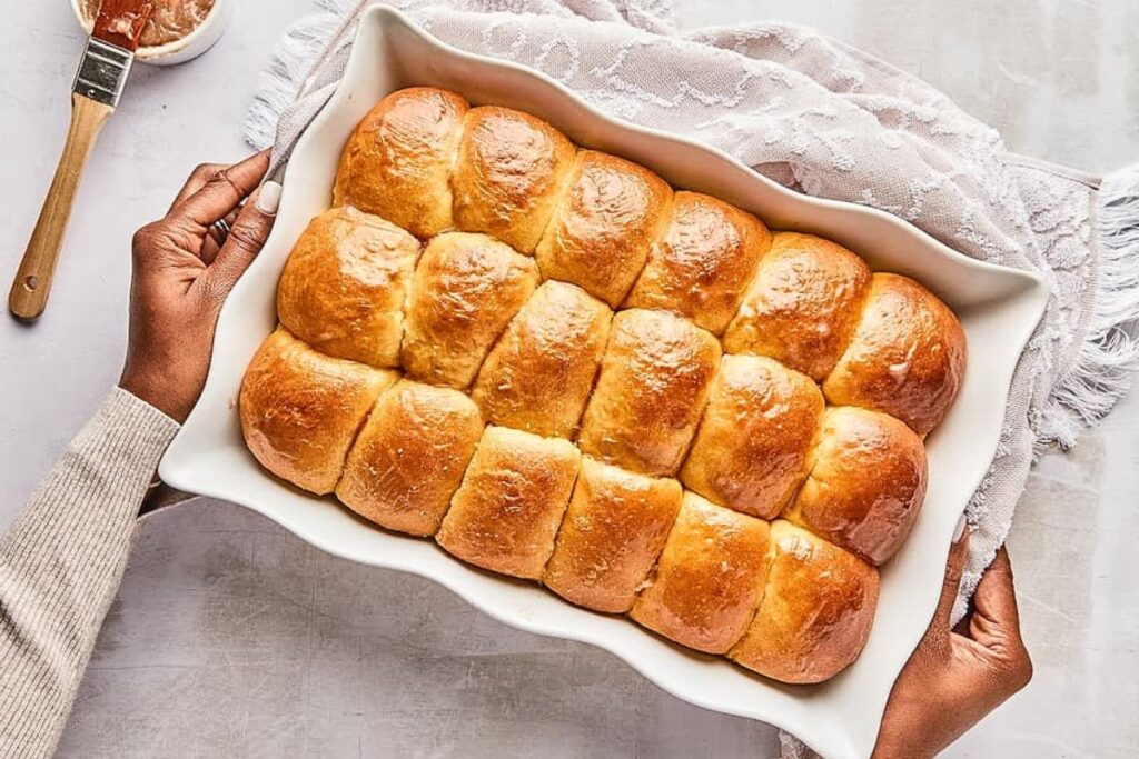A pan of golden brown dinner rolls.