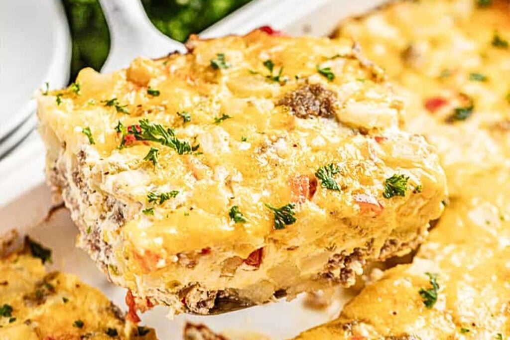 A casserole with cheese and hashbrowns and sausage.