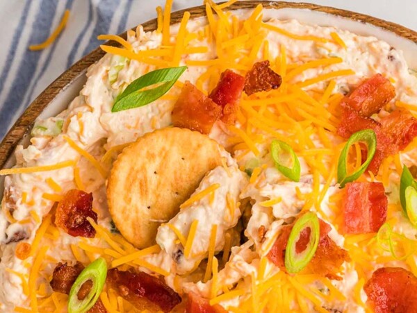 Above view of million dollar dip in a dish topped with bacon.