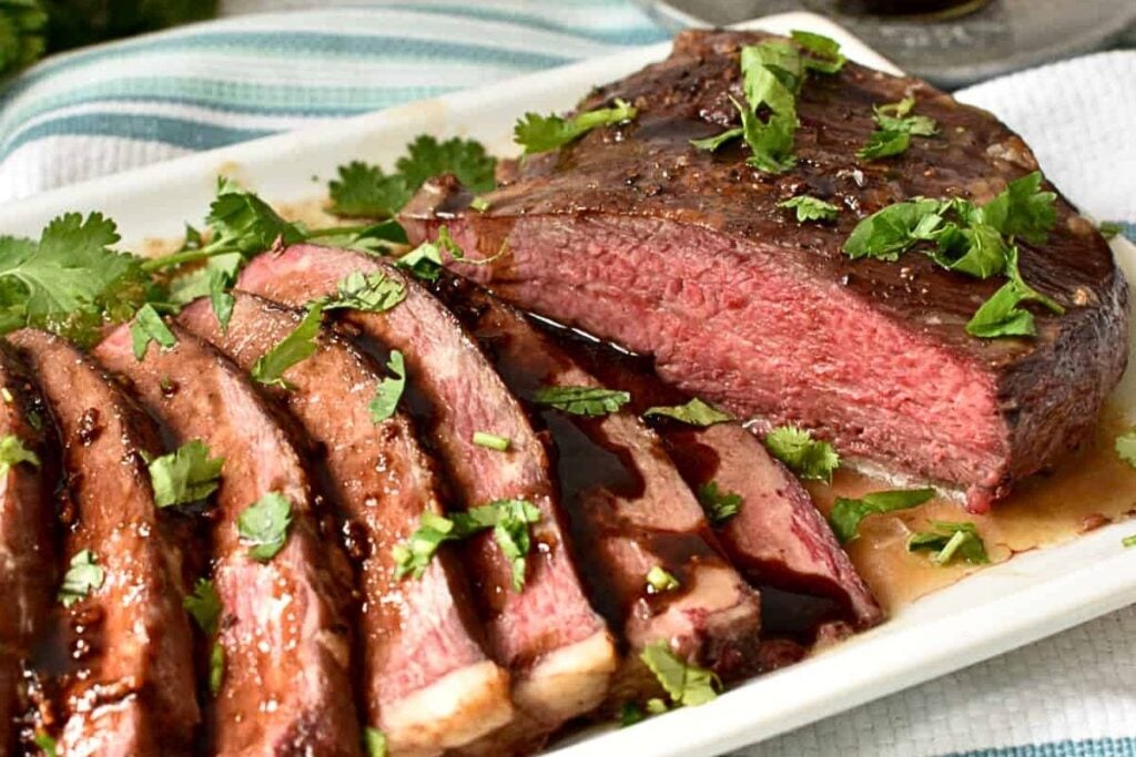 A platter of thin sliced tri tip.