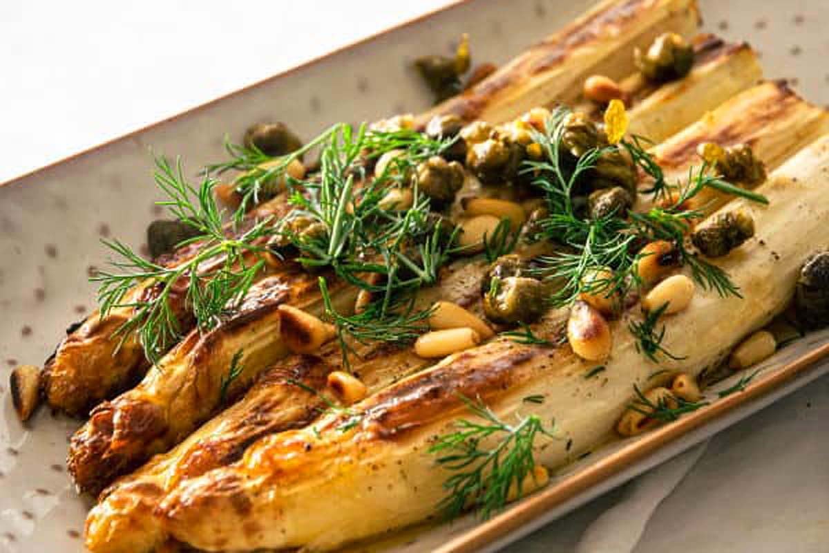 Asparagus with capers on a platter.