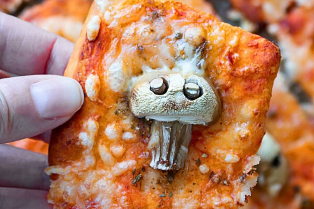 A cheese pizza with mushroom skulls.