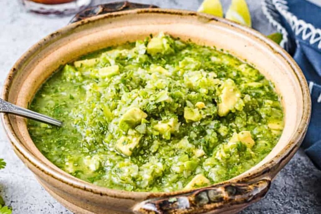 A dish of green tomatillo and jalapeno salsa.