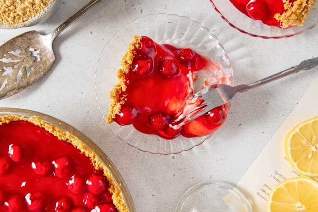 A slice of creamy no bake cherry cheesecake on a plate.