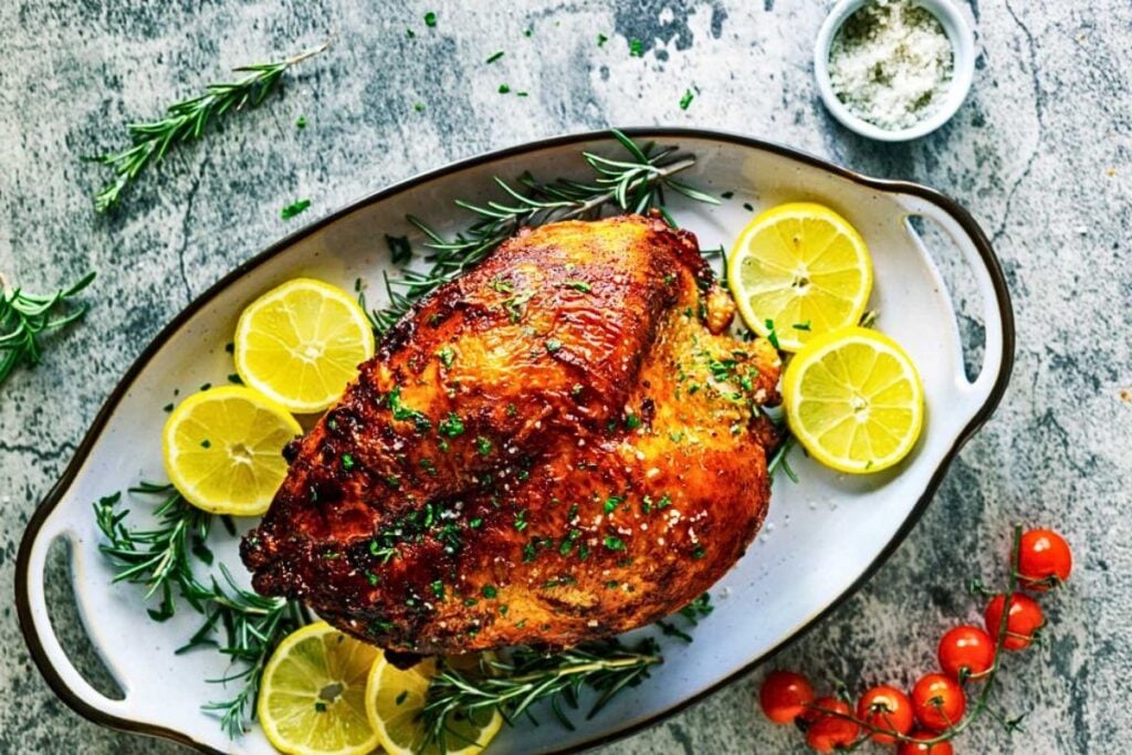 A golden brown turkey breast on a platter.