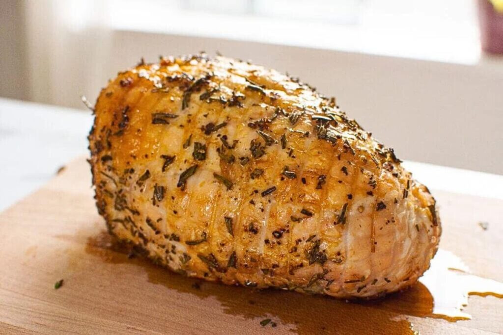 Herb roasted turkey breast on a serving platter.