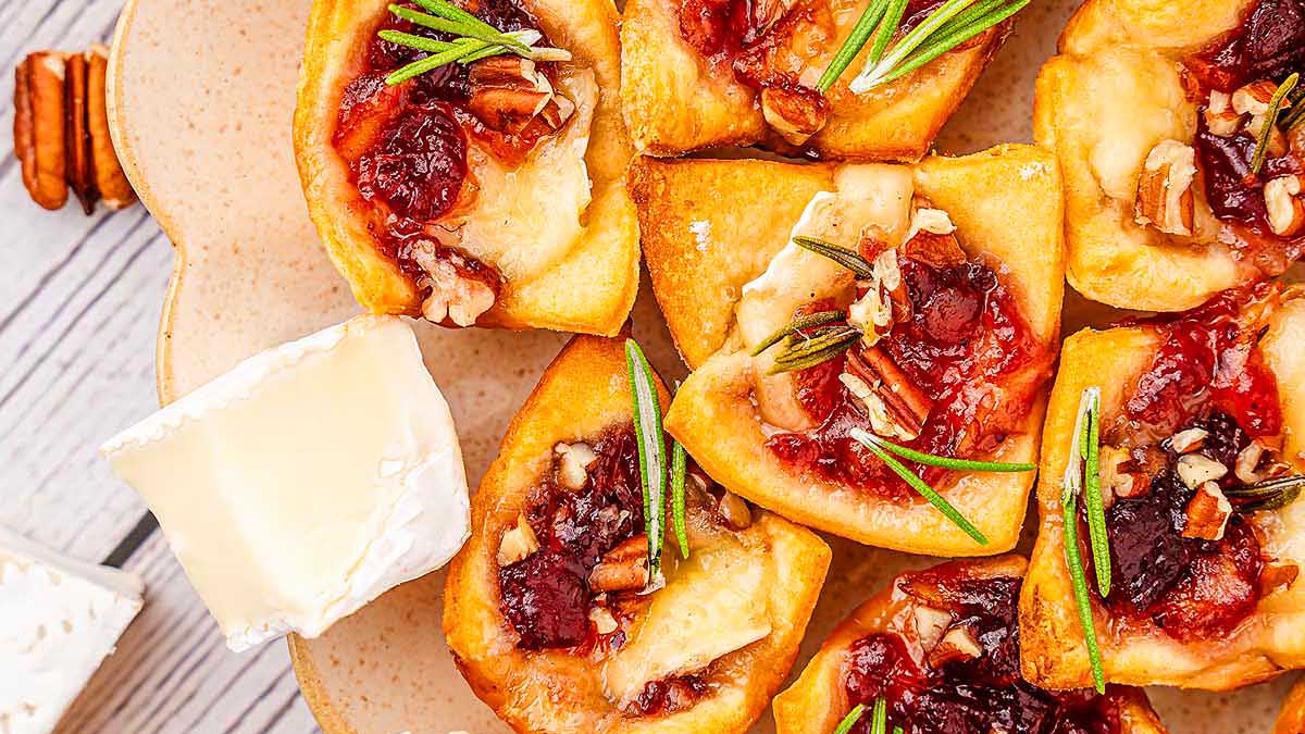 One-bite cranberry and pecan appetizers on a wooden table.