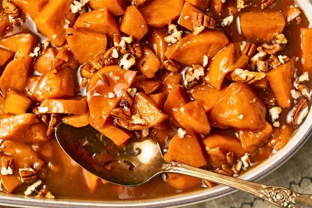 A casserole of candied sweet potatoes with crunchy pecans.