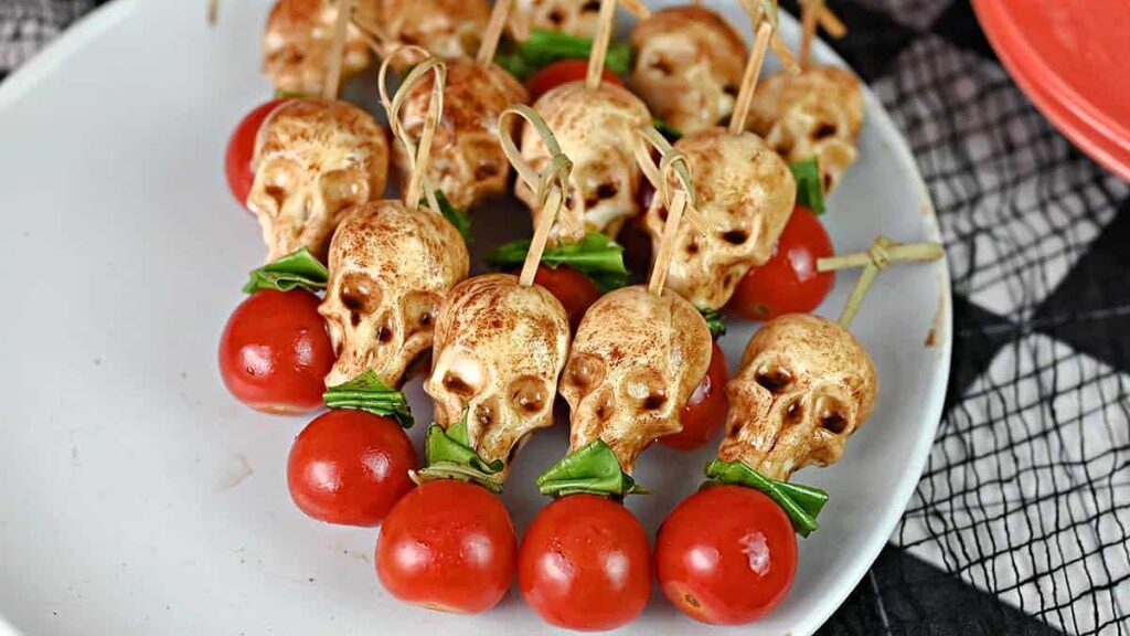 Skull caprese skewers on a plate.
