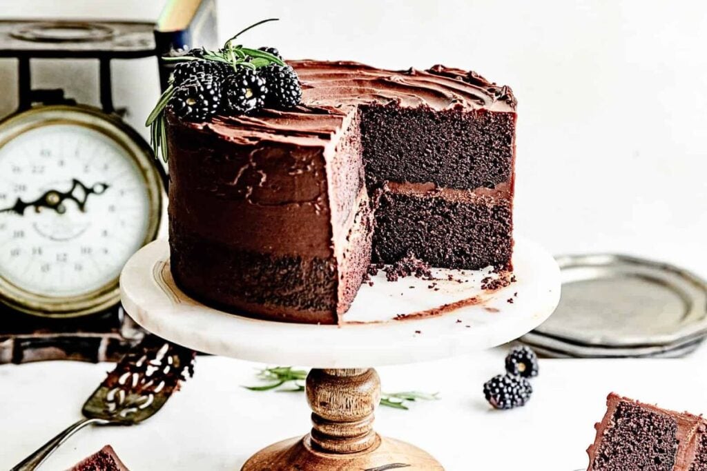 A chocolate layer cake with chocolate ganache frosting, sliced.