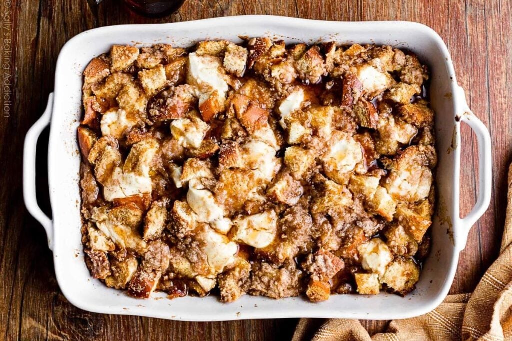 A casserole dish filled with cream cheese and french toast cubes.