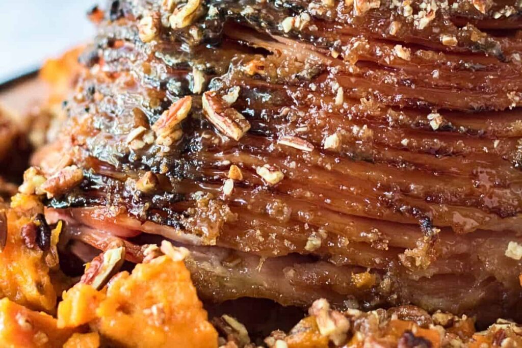 A pecan praline glazed ham on a serving platter.