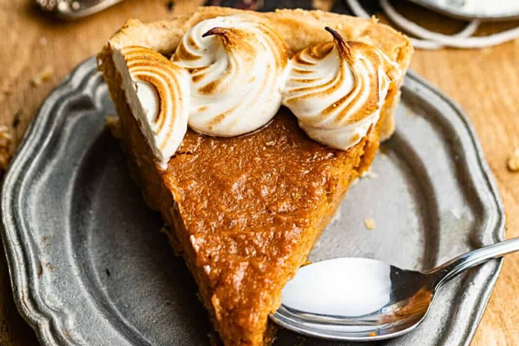 A slice of sweet potato pie with a few bites missing.