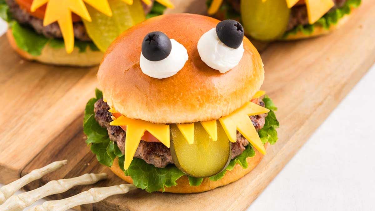 Burger that set up like a monster with a pickle hanging out.