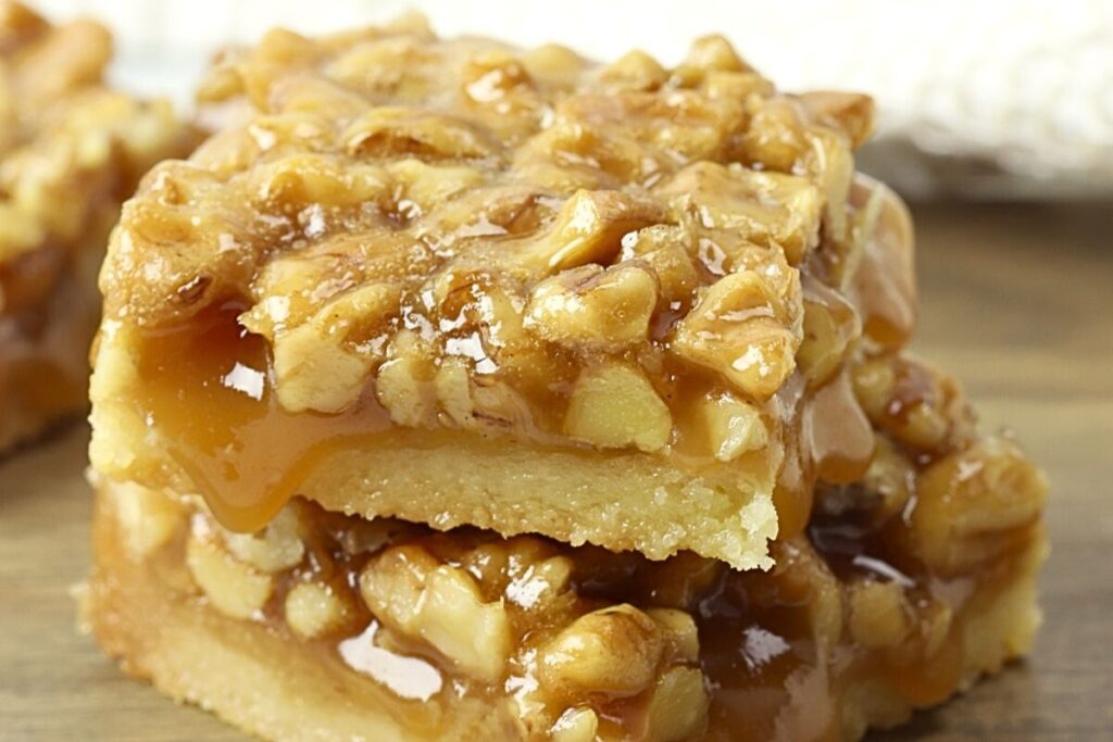 Two honey walnut shortbread bars stacked on top of each other.
