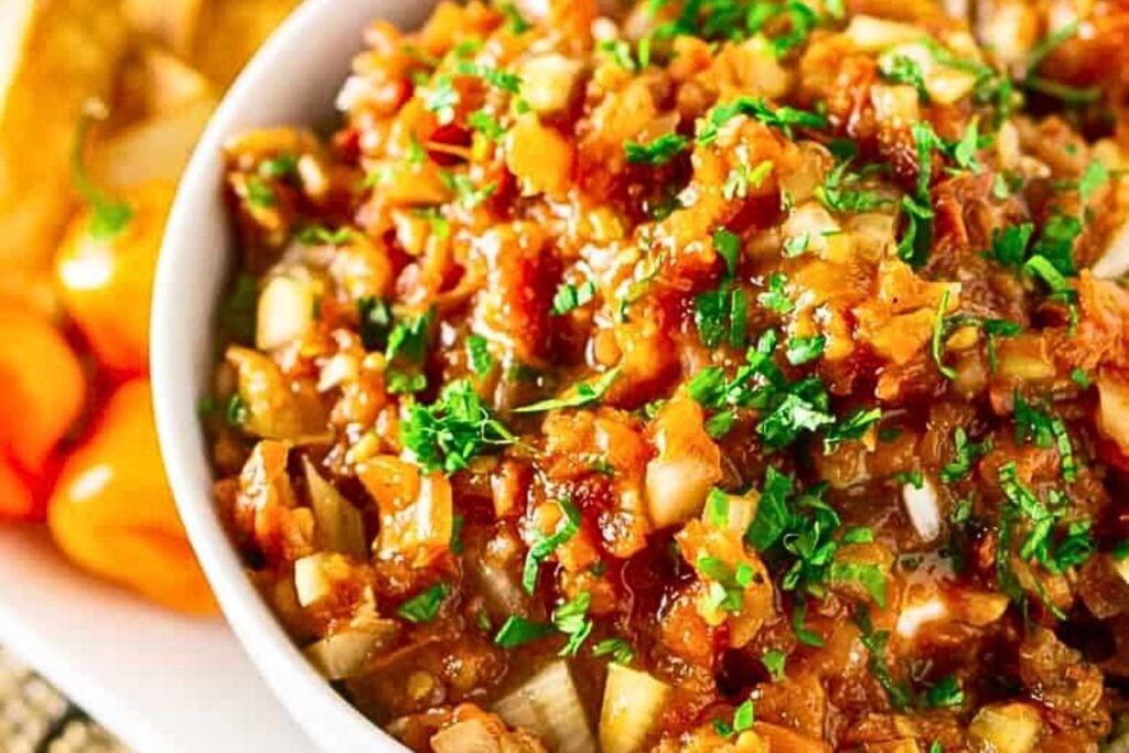 A bowl of salsa with Jamaican jerk seasoning.