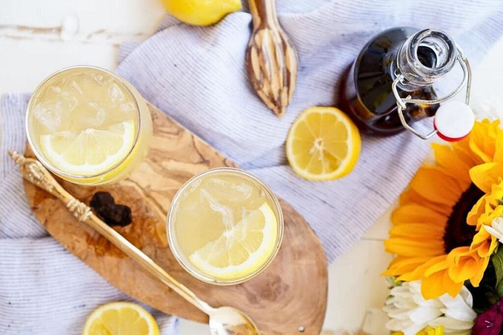 Overhead glasses with Maine maple syrup lemonade with slices of lemon.
