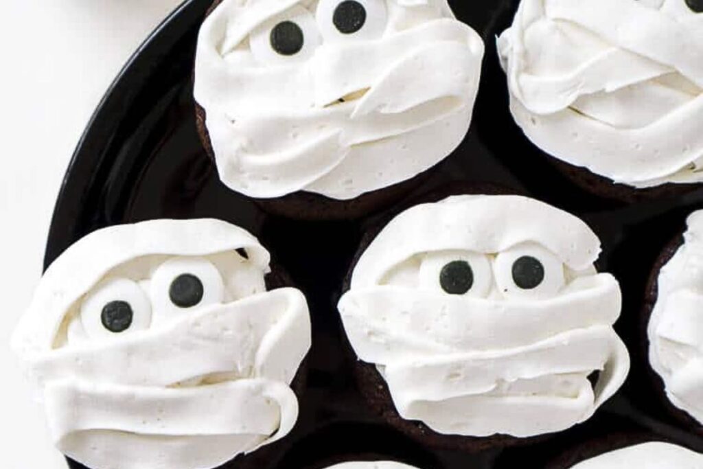 Cupcakes frosted to look like mummies. Complete with eyes.