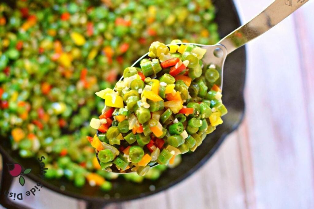 A serving spoon of diced green beans.