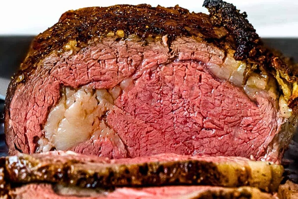 A juicy prime rib roast, sliced.