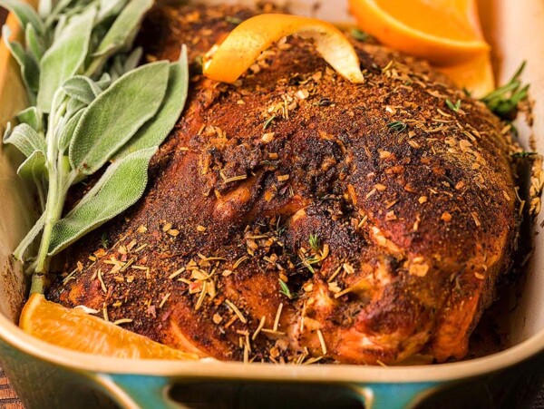 A turkey breast cooking in a dish.