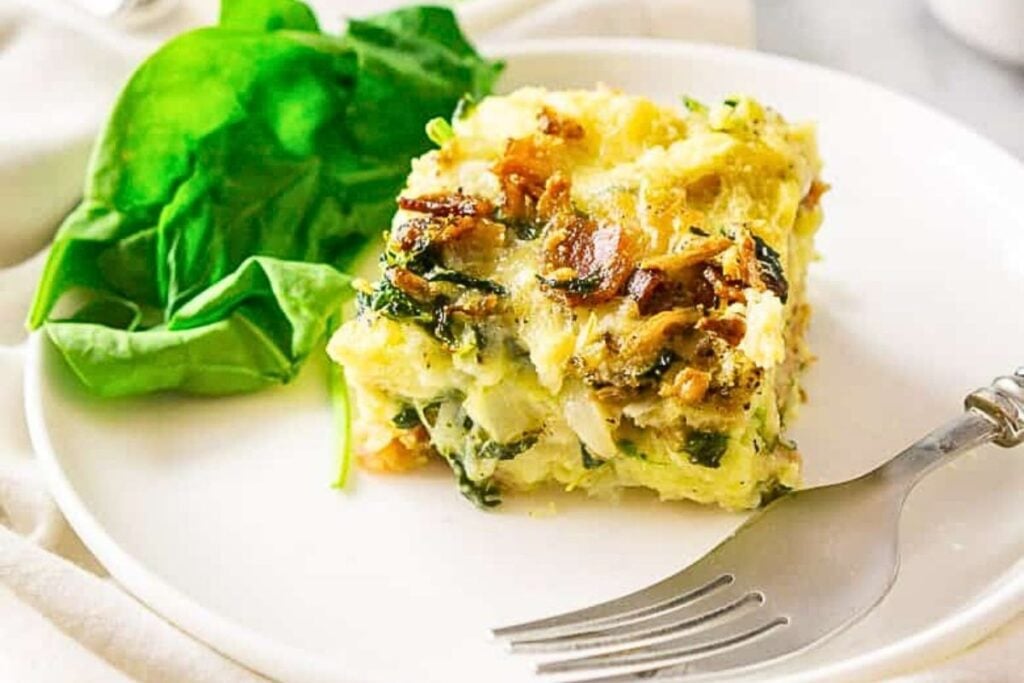 A slice of breakfast strata on a plate.