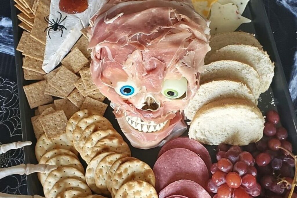 A charcuterie board with a proscuitto skull.