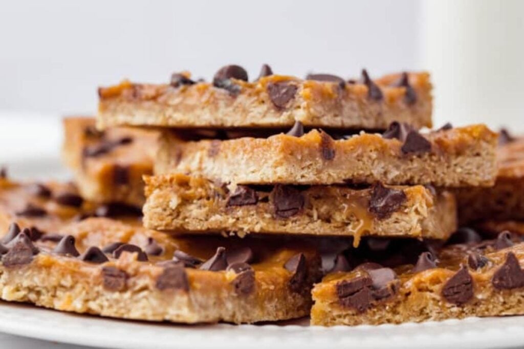 A plate of caramel oatmeal bars with chocolate chips.