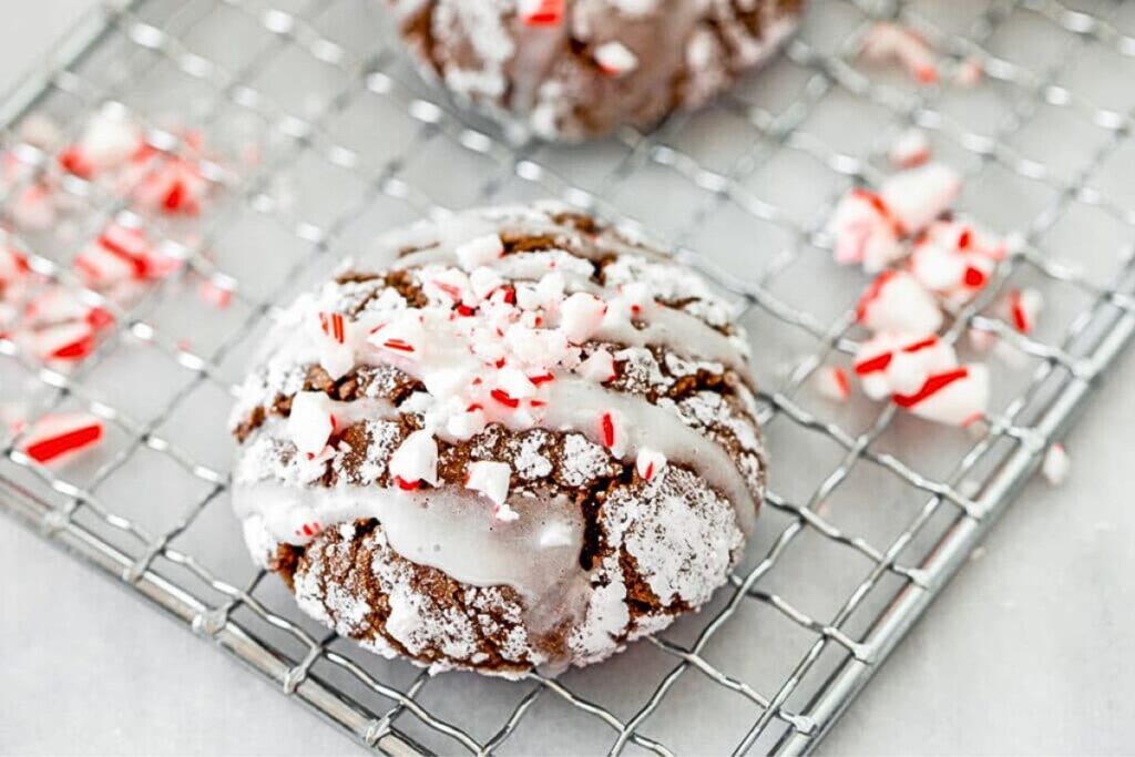 A cooling rack with chocolate sour cream cookies with peppermint.