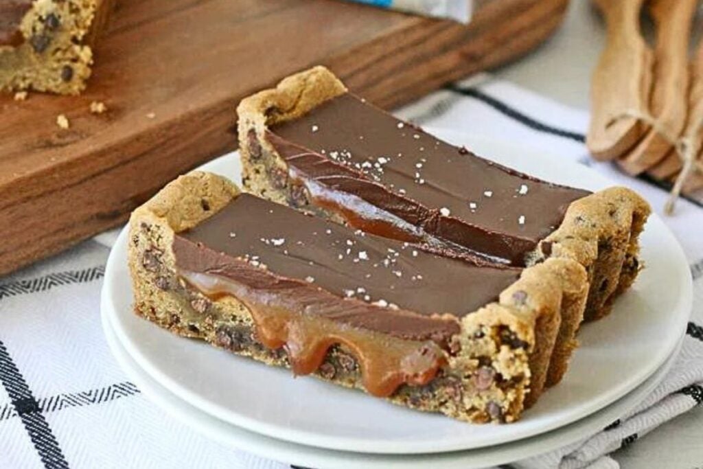 Slices of chocolate chip cookie tart filled with salted caramel.