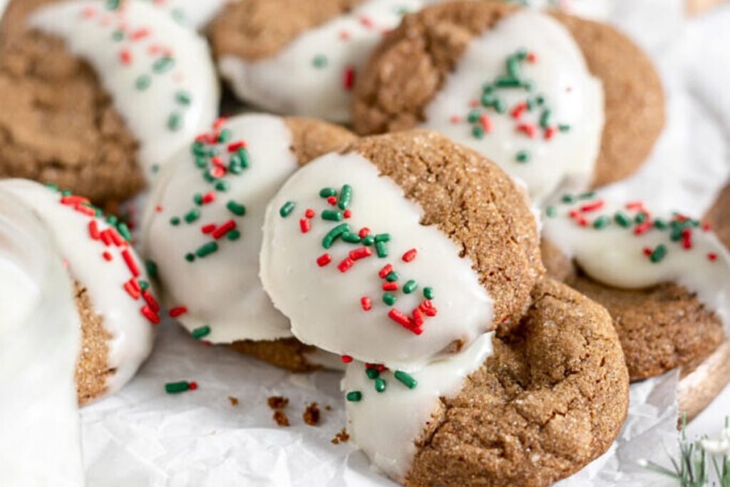 A platter of dipped gingerbread cookies with sprinkles.