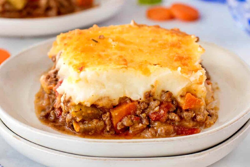 A piece of cottage pie on a plate.