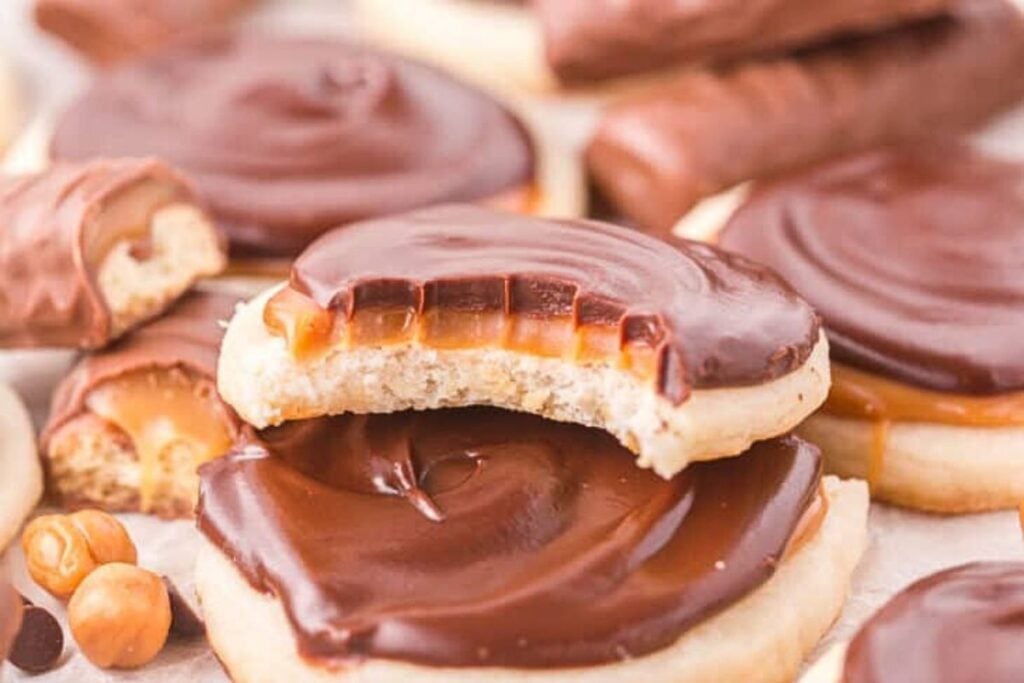 Chocolate and caramel covered shortbread cookies. One bite missing.