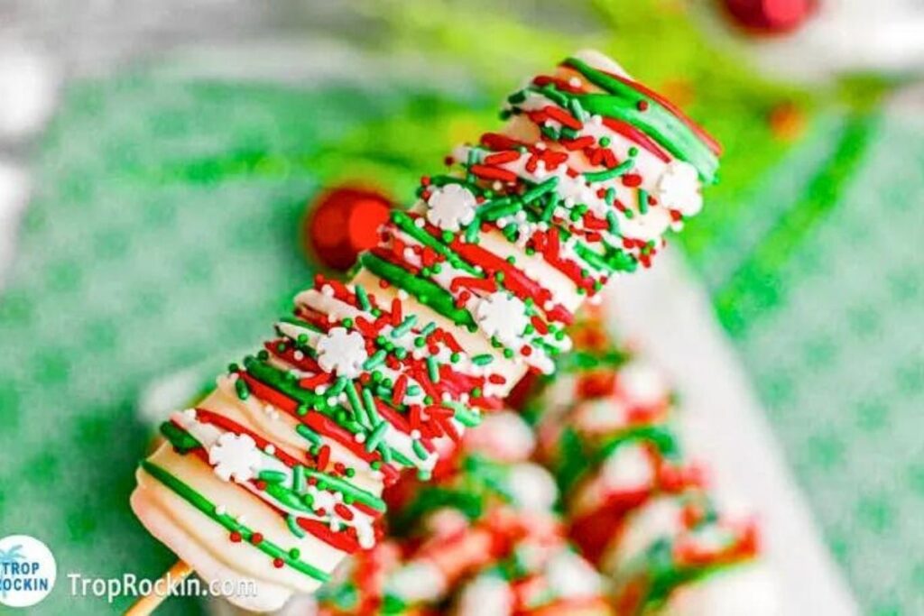 Marshmallows dipped in white chocolate and decorated with sprinkles and chocolate drizzles.