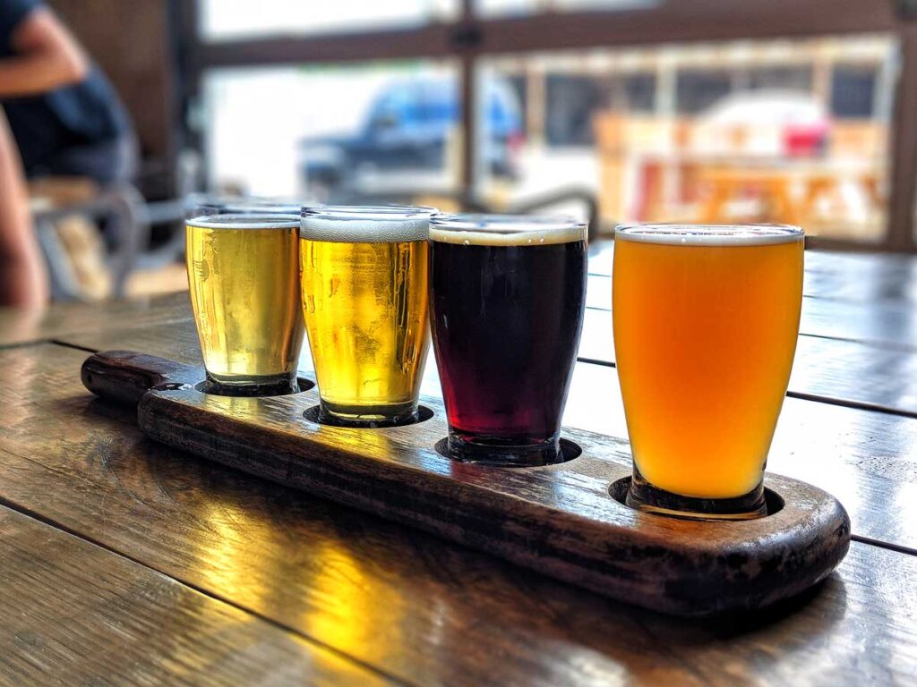 Beer flight on polished wood table at brewery in Indianapolis, Indiana.