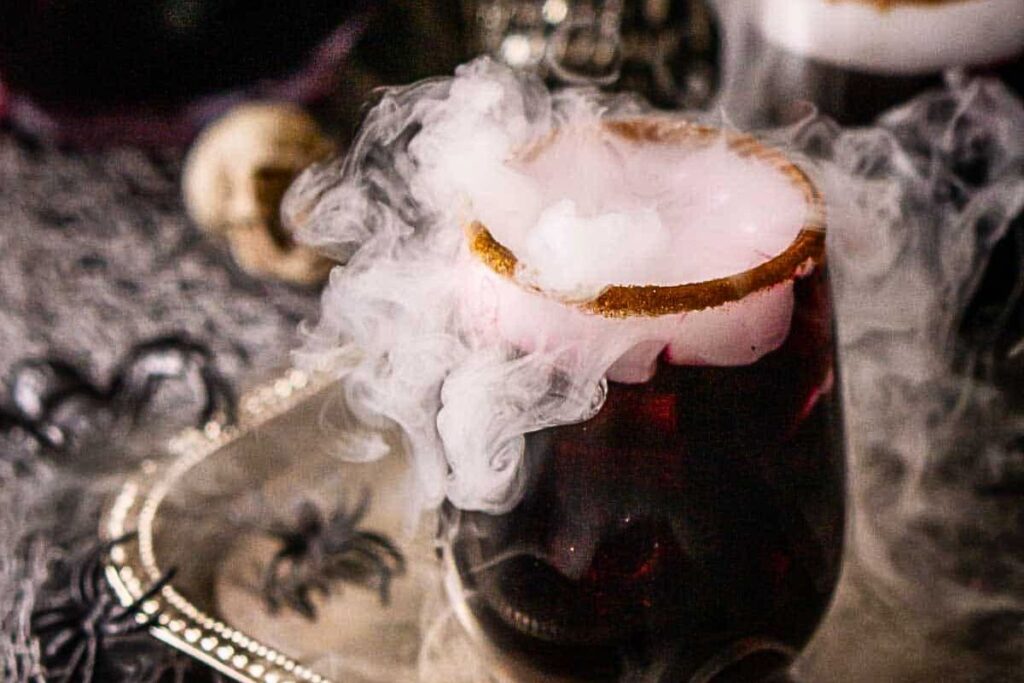 A smoky dark red punch in a glass.