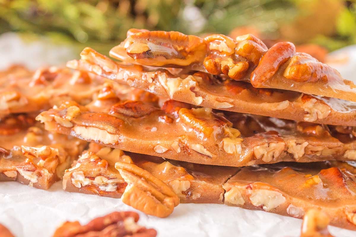 A stack of nut brittle on top of a piece of paper.