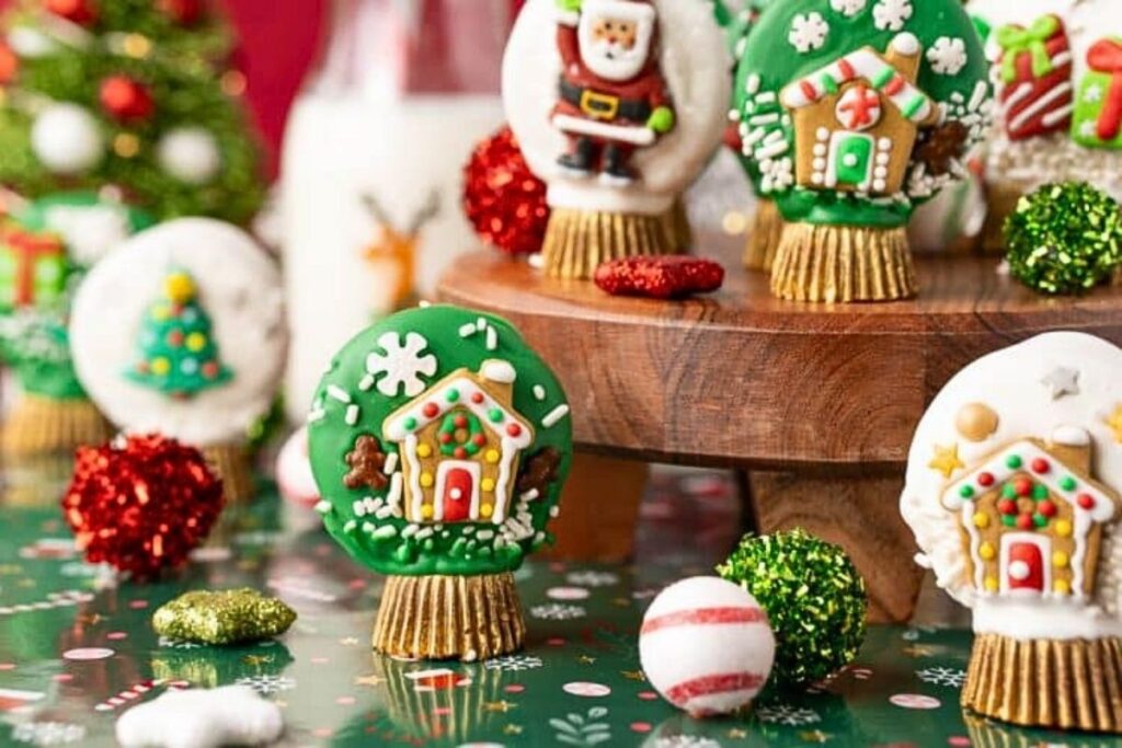 Christmas dipped oreo cookies that look like adorable snow globes, with a peanut butter cup base.