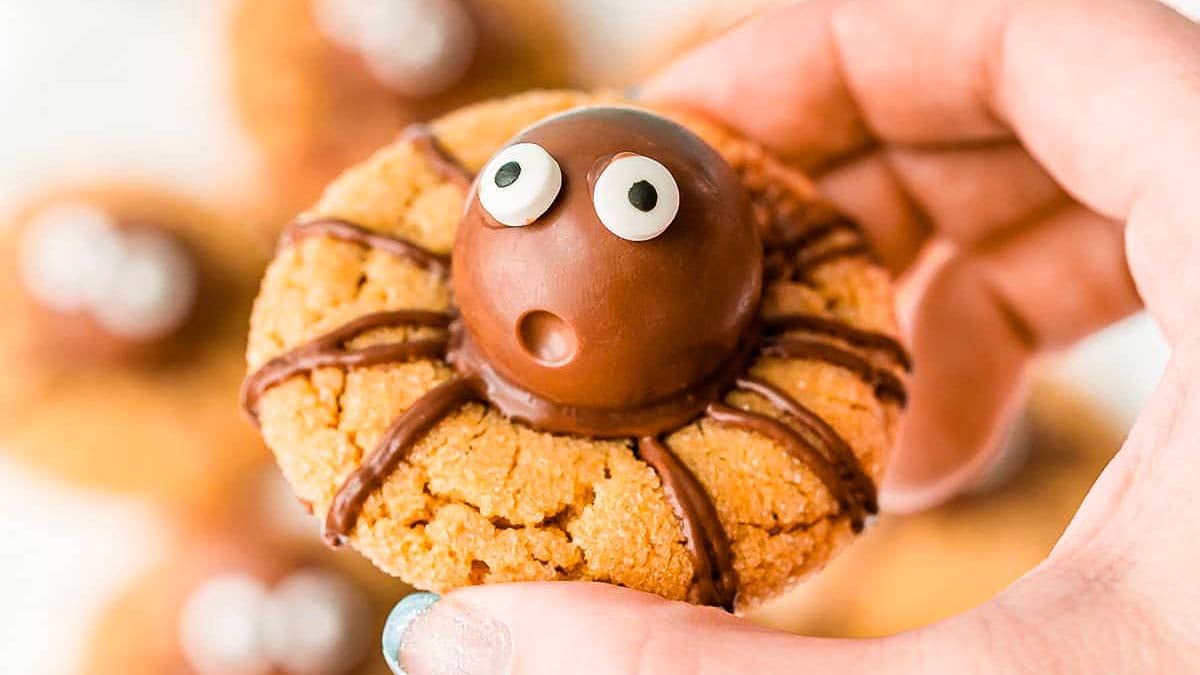 Peanut butter cookies topped with truffles and candy eyes to look like spiders.