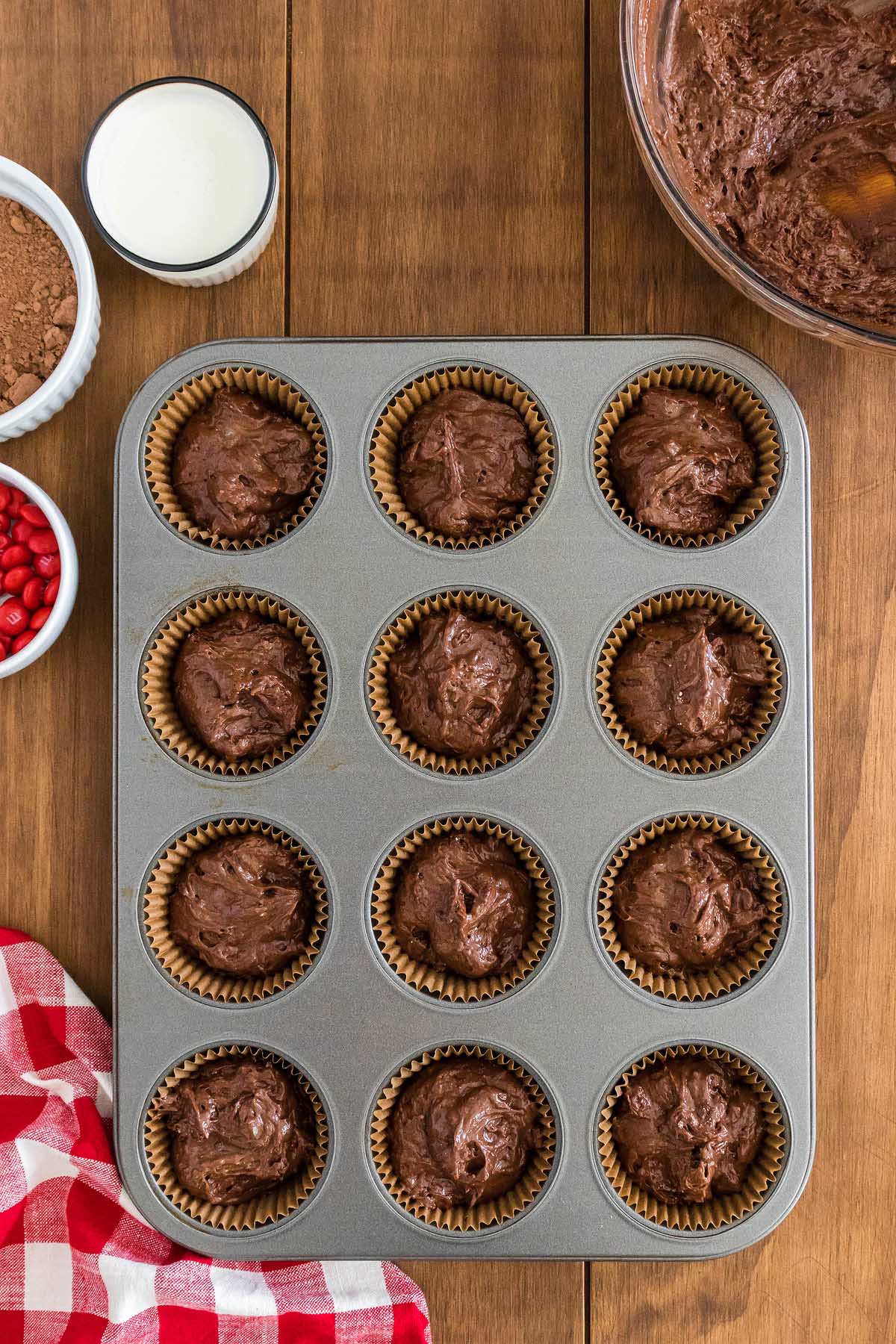 Rudolph cupcakes in a muffin tin on a wooden table.