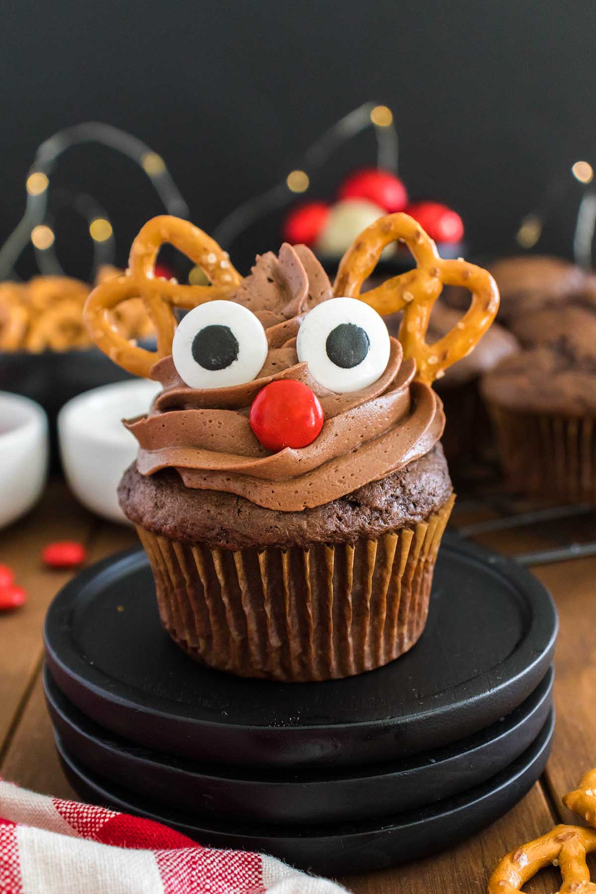 Rudolph cupcakes with pretzels on a plate.