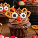 Reindeer cupcakes with pretzels on top.
