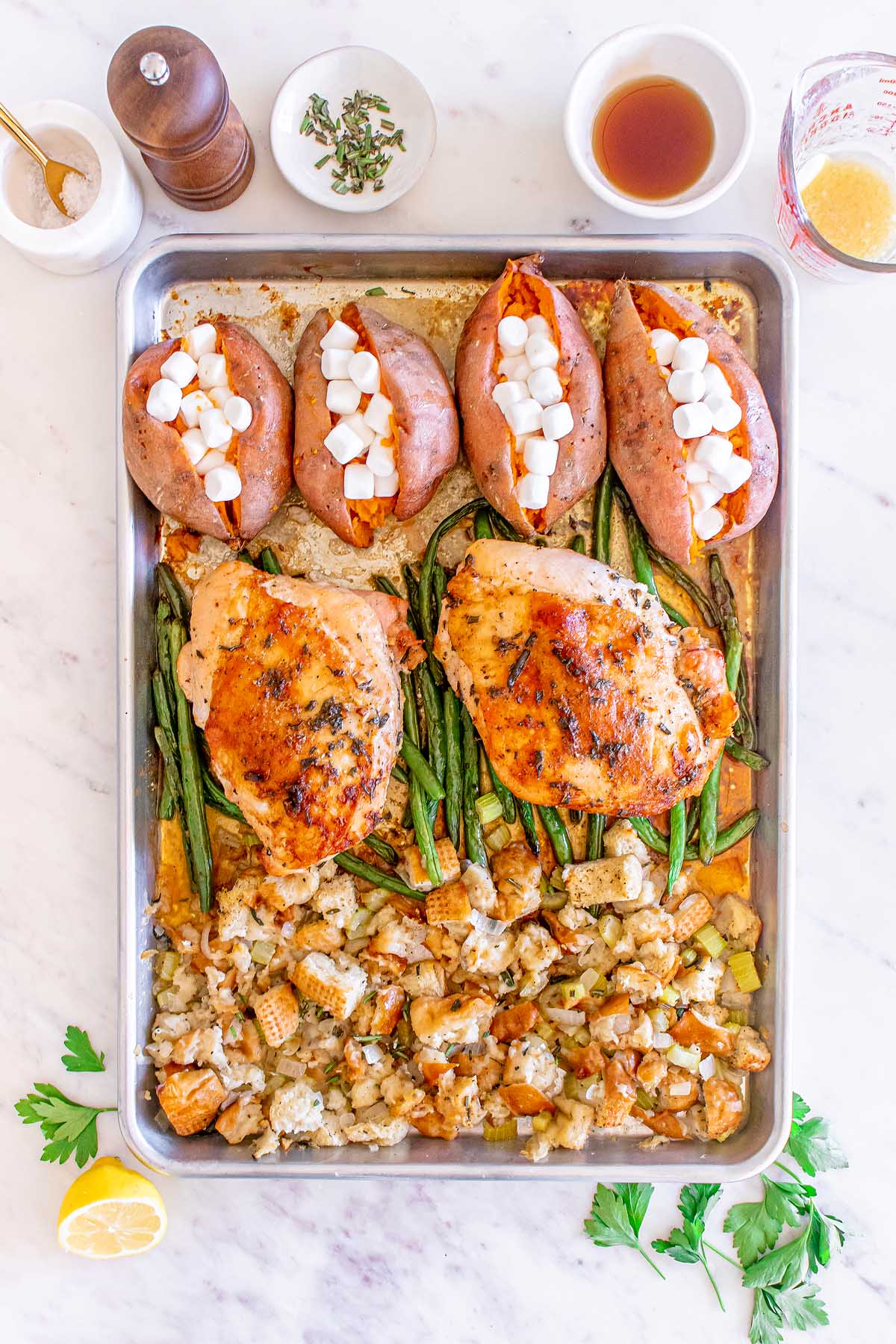 Roasted sweet potatoes and turkey on a Thanksgiving baking sheet.