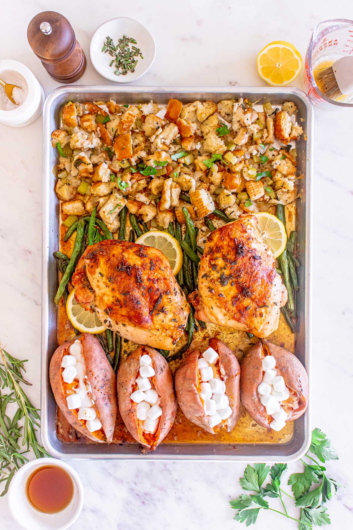 Roasted turkey and potatoes on a baking sheet.