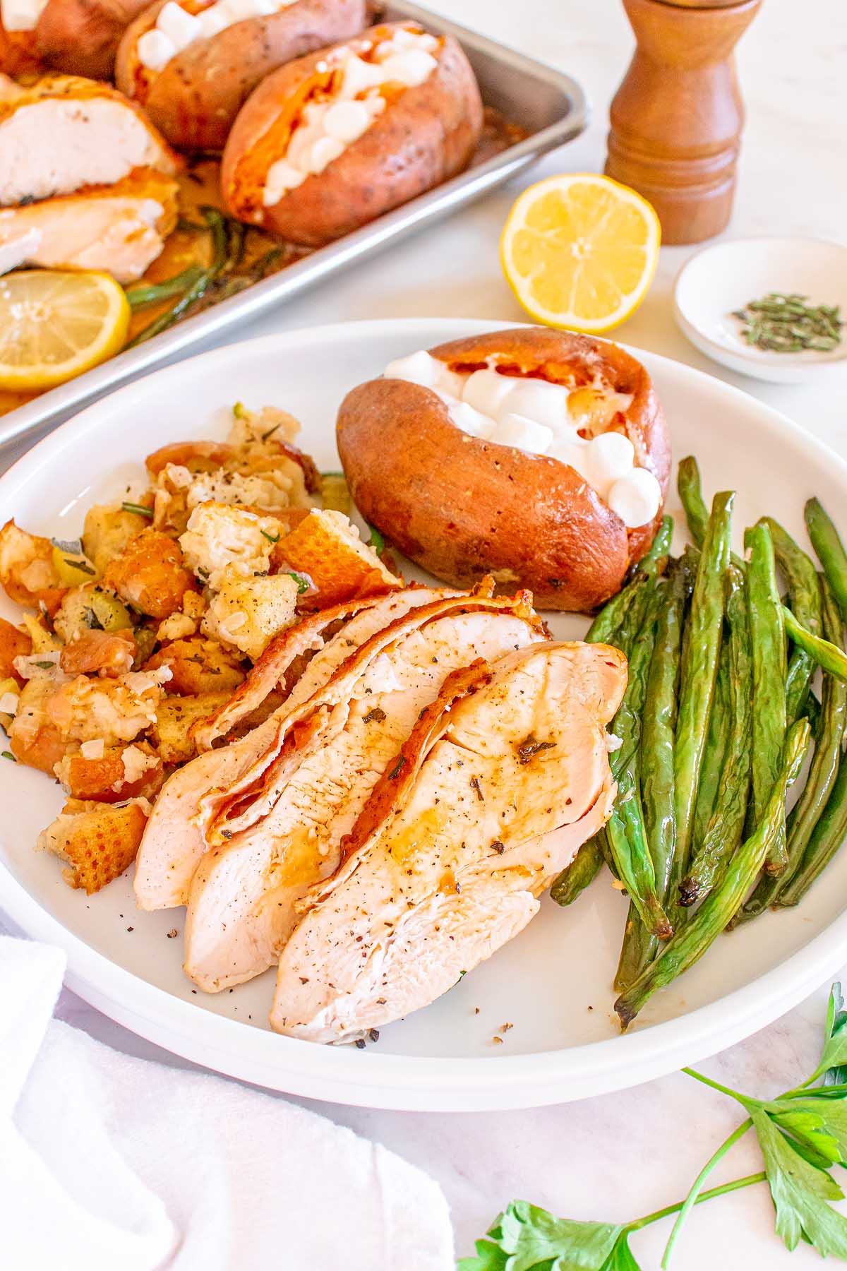 A plate with turkey, green beans and potatoes.